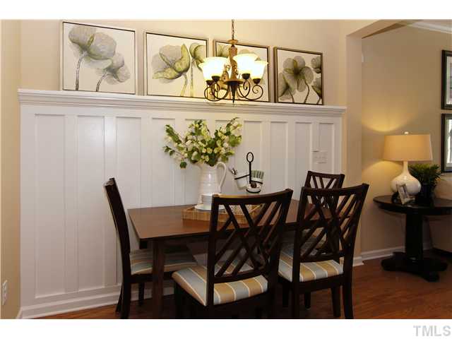 759 Wickham Ridge Road, Unit 105 Apex, NC 27539 - Photo 6 of 25 a view of a dining room with furniture and wooden floor