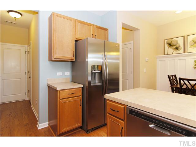 759 Wickham Ridge Road, Unit 105 Apex, NC 27539 - Photo 10 of 25 a kitchen with stainless steel appliances a refrigerator and a stove