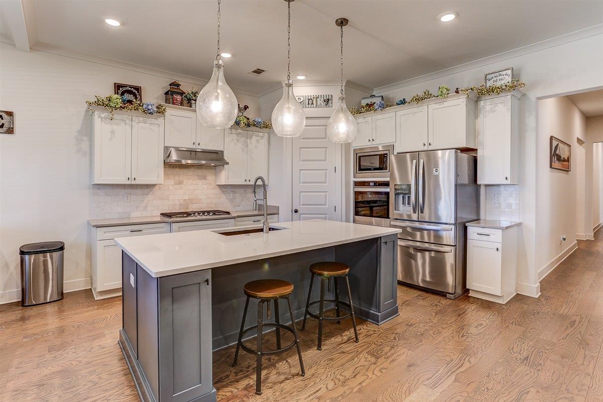 5566 Gerber Road Arlington, TN 38002 - Photo 12 of 33 a kitchen with stainless steel appliances a sink a stove a refrigerator and island