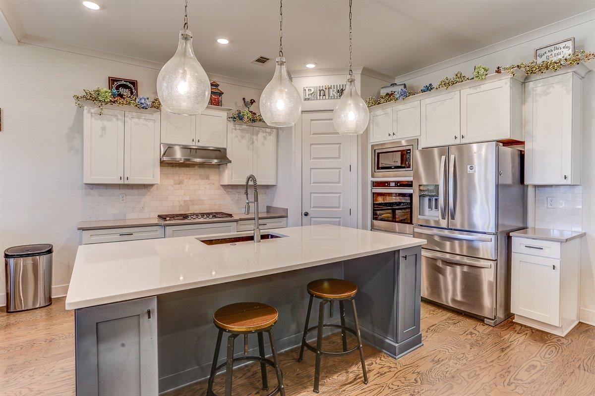5566 Gerber Road Arlington, TN 38002 - Photo 13 of 33 a kitchen with stainless steel appliances a sink a stove a refrigerator and cabinets