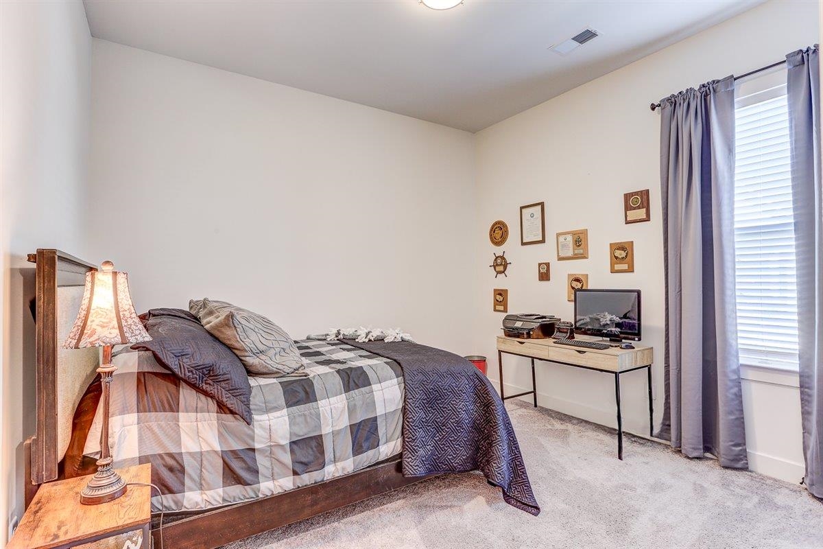 5566 Gerber Road Arlington, TN 38002 - Photo 17 of 33 a bedroom with a bed and a cabinets