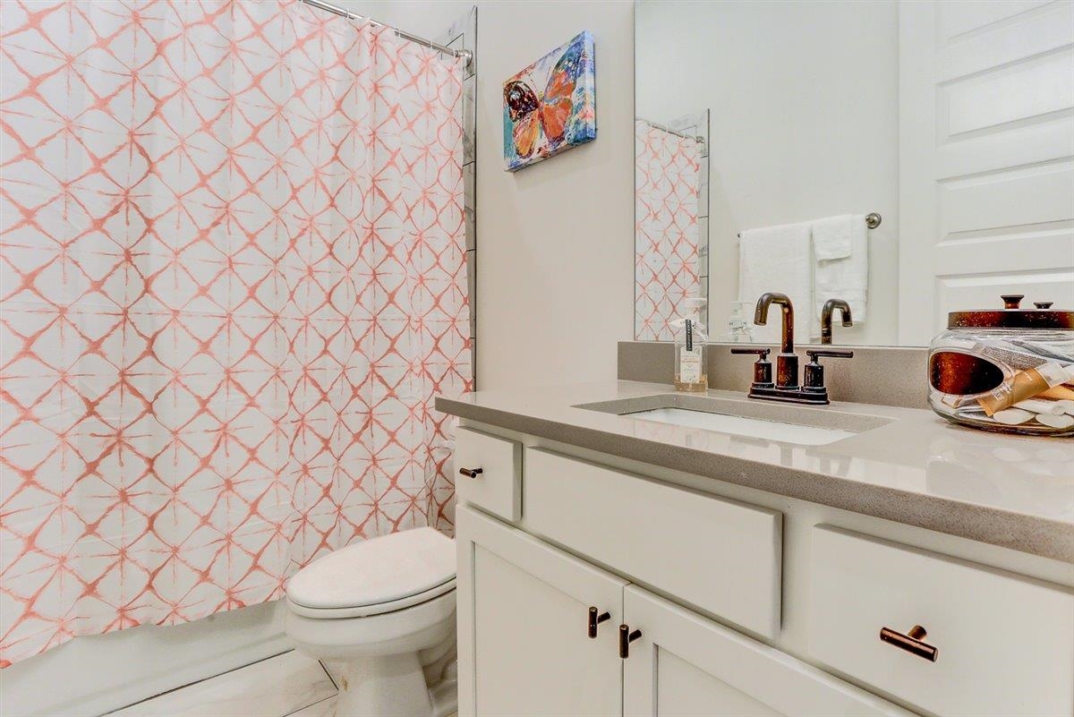 5566 Gerber Road Arlington, TN 38002 - Photo 18 of 33 a bathroom with a sink a toilet and a shower curtain