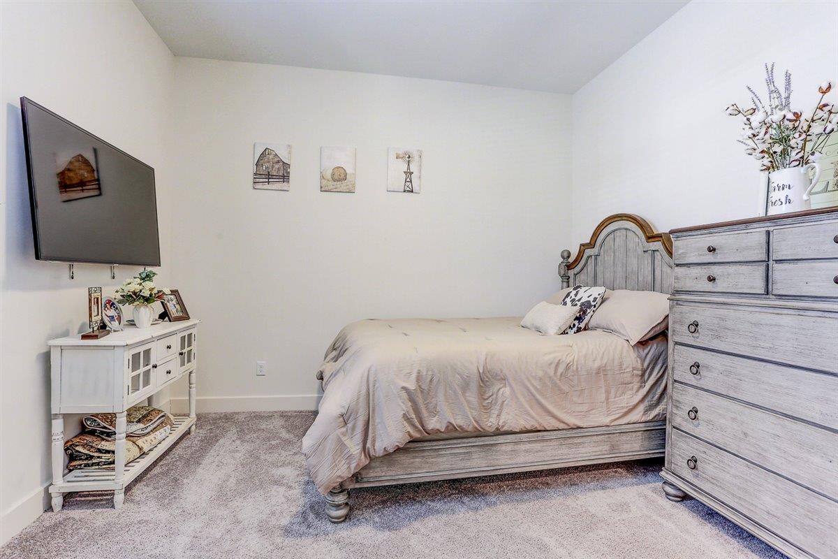 5566 Gerber Road Arlington, TN 38002 - Photo 20 of 33 a bedroom with a bed and a flat tv screen on the dresser