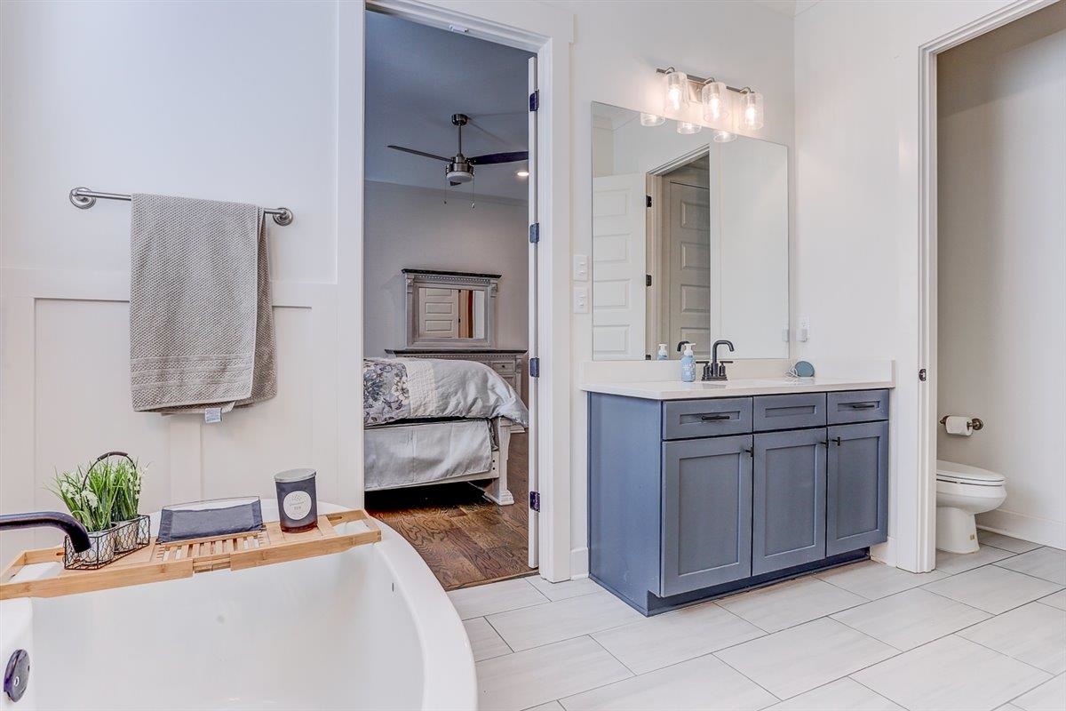 5566 Gerber Road Arlington, TN 38002 - Photo 25 of 33 a bathroom with a granite countertop sink and a mirror