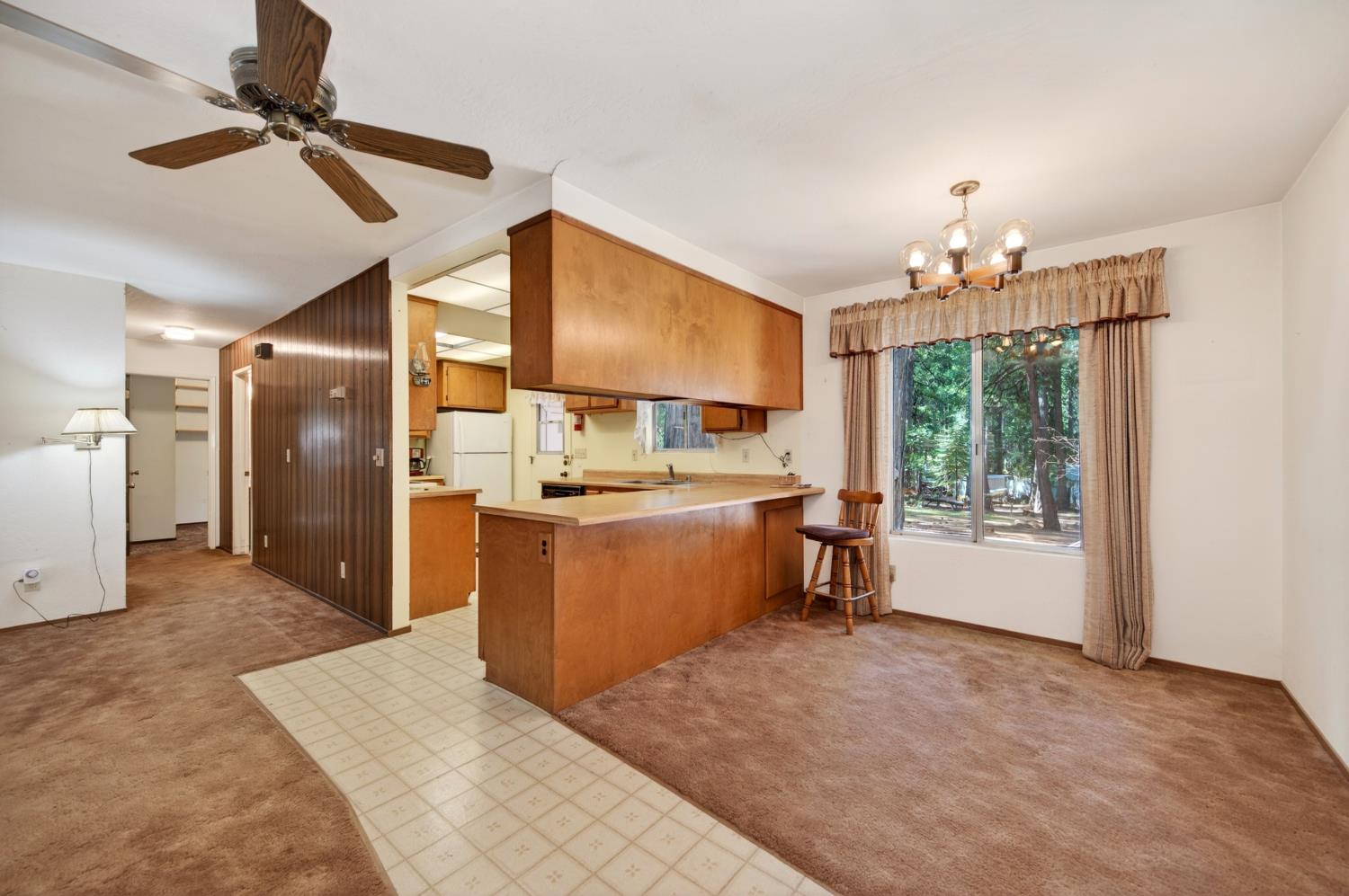 20191 Kit Court Volcano, CA 95689 - Photo 23 of 54 a kitchen with kitchen island a counter top space appliances and a ceiling fan