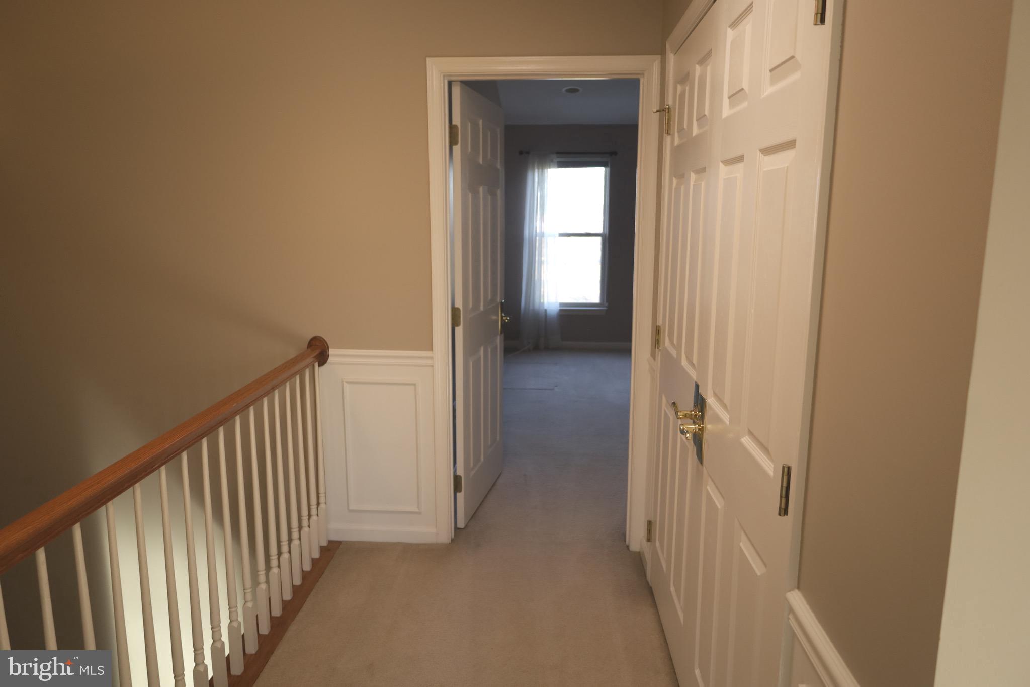 21543 Trowbridge Square Ashburn, VA 20147 - Photo 25 of 60 a view of a hallway with a wooden door