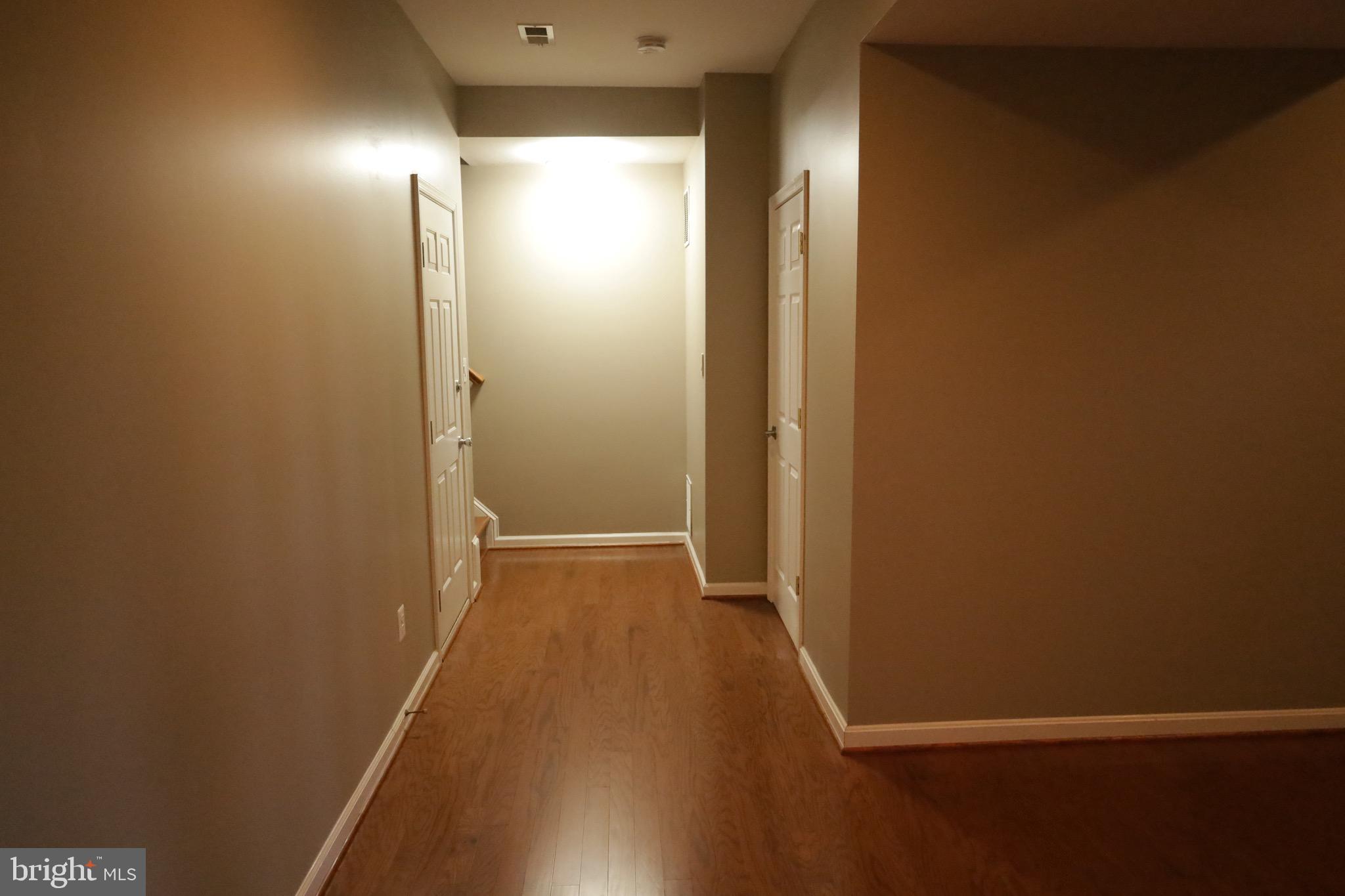 21543 Trowbridge Square Ashburn, VA 20147 - Photo 39 of 60 an empty room with wooden floor and windows
