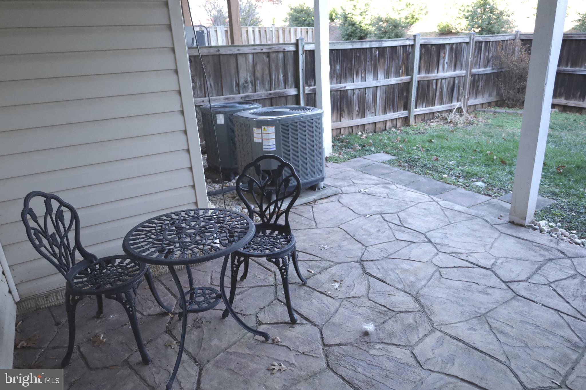 21543 Trowbridge Square Ashburn, VA 20147 - Photo 46 of 60 a table and chair sitting in backyard of house