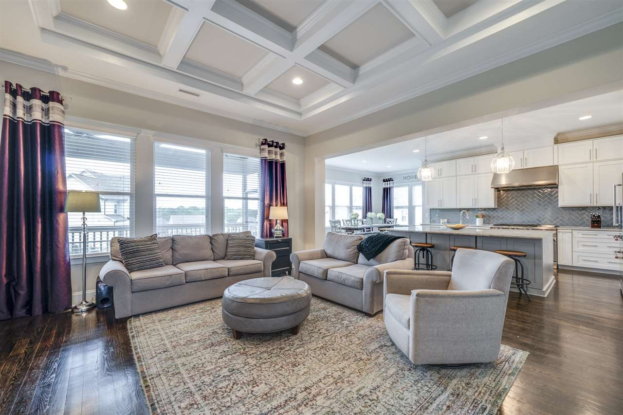 7504 Pinaster Place Raleigh, NC 27613 - Photo 6 of 30 Relax in this spacious family room fully equipped w/ site finish hardwoods, coffered ceiling, recessed can lights, built-in shelves and more! Family Room
