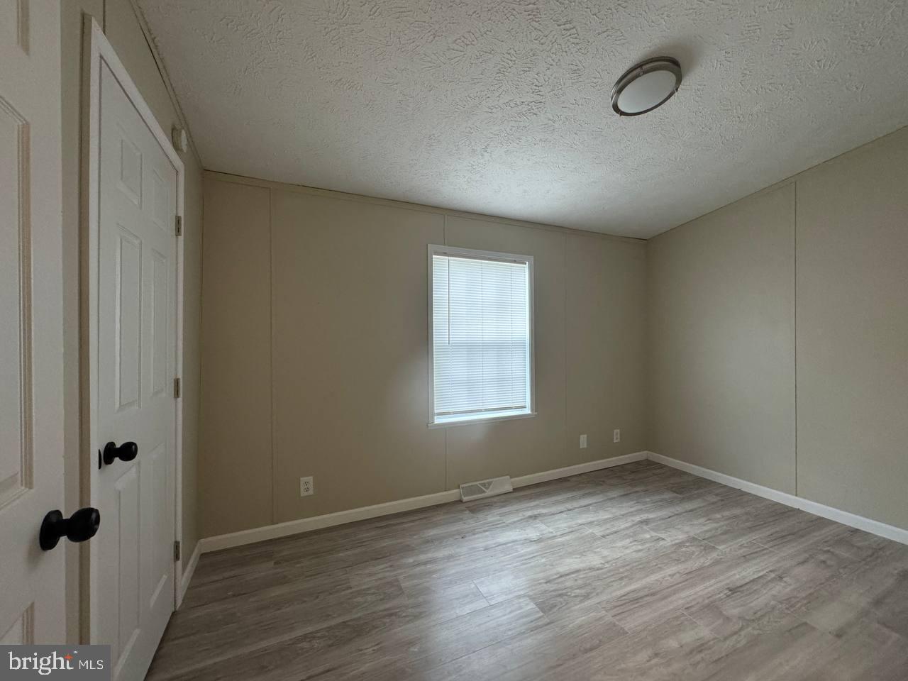 235 Poclain Road Aberdeen, MD 21001 - Photo 13 of 28 an empty room with wooden floor and windows