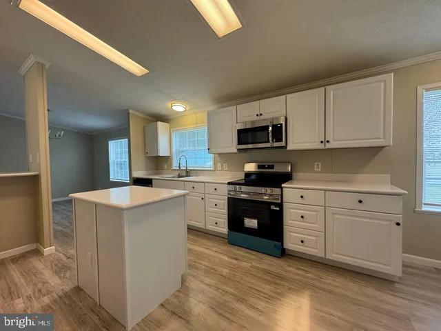 a kitchen with a stove top oven sink and cabinets