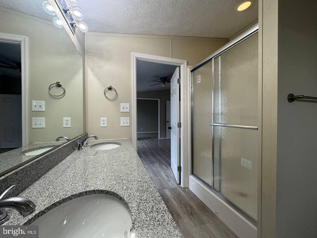 235 Poclain Road Aberdeen, MD 21001 - Photo 21 of 28 a en suite bathroom with a granite countertop sink a mirror and shower