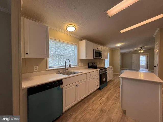 a kitchen with stainless steel appliances granite countertop a sink and cabinets