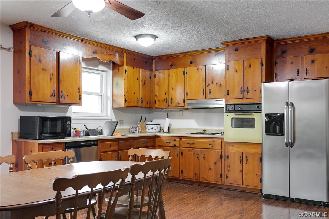 900 Jordan Point Road Hopewell, VA 23860 - Photo 12 of 41 a kitchen with stainless steel appliances granite countertop a stove a sink a microwave refrigerator and chairs