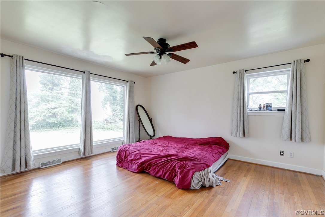 900 Jordan Point Road Hopewell, VA 23860 - Photo 17 of 41 a view of a bedroom with a bed and wooden floor