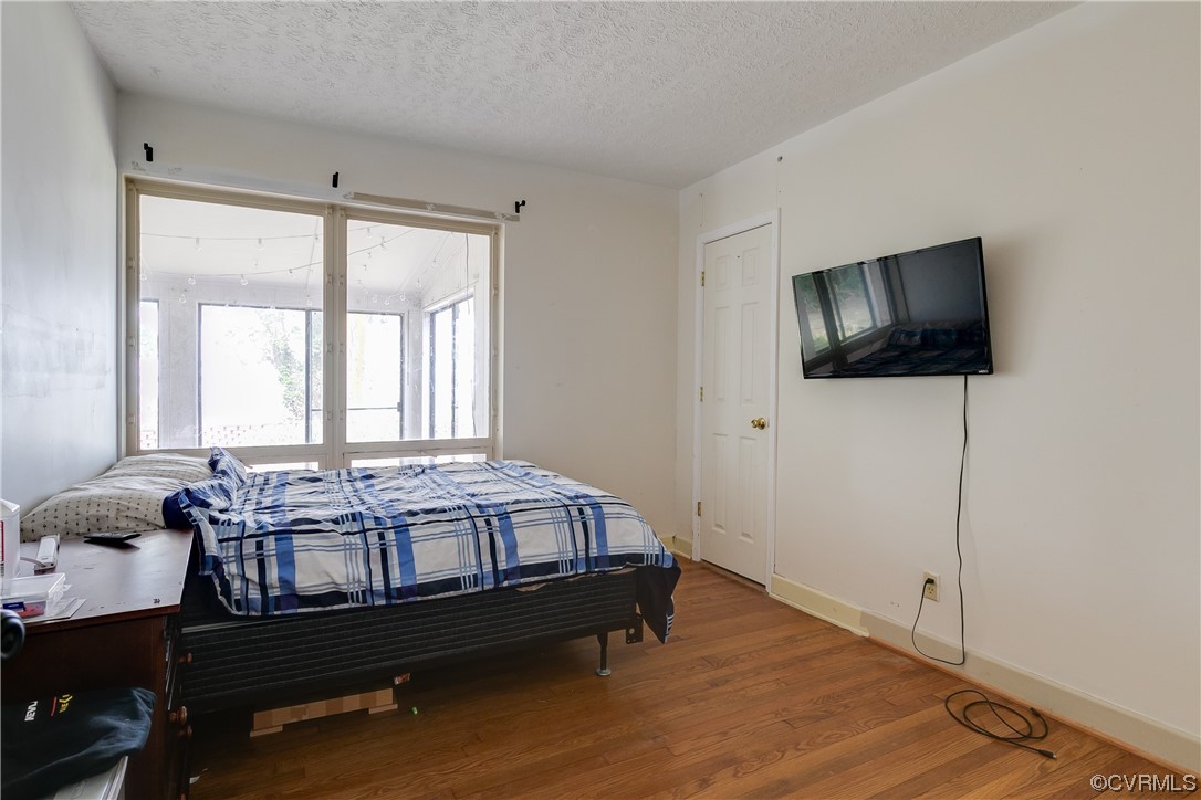 900 Jordan Point Road Hopewell, VA 23860 - Photo 19 of 41 a bedroom with a bed window and flat screen tv