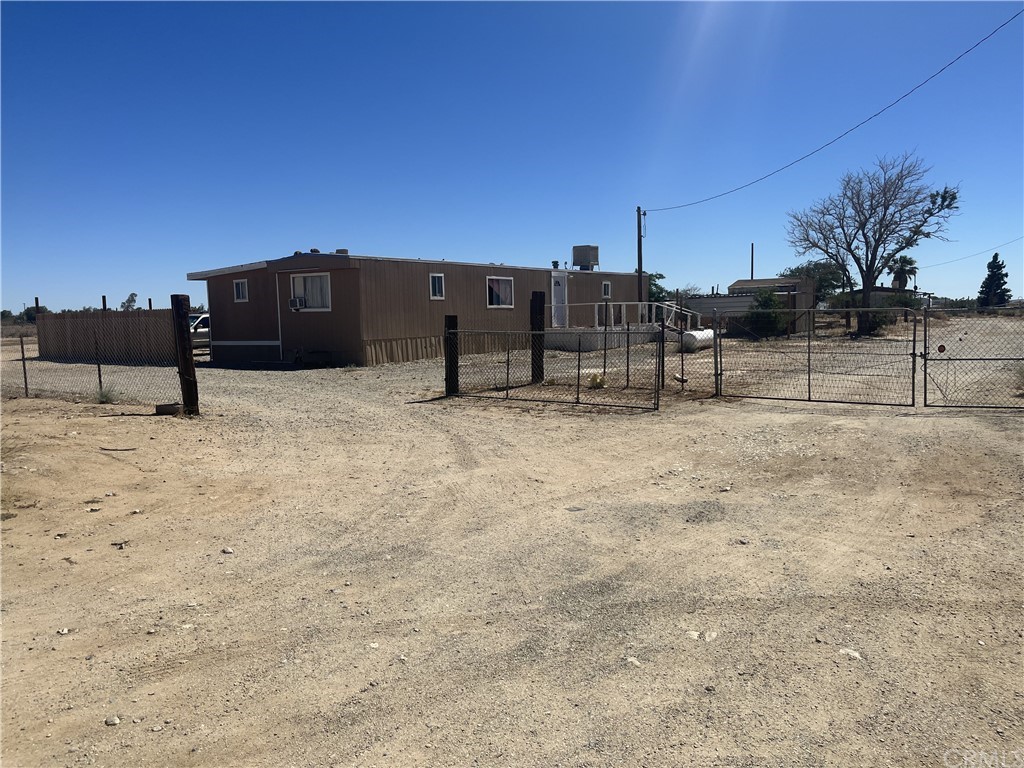 a view of a house with wooden fence