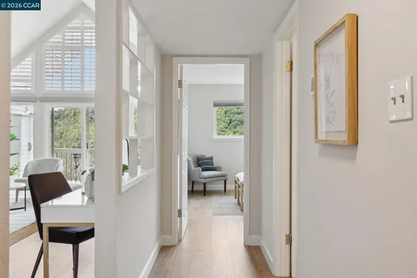 a view of a hallway with a livingroom and a window