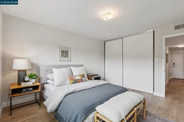a bedroom with a bed and a lamp