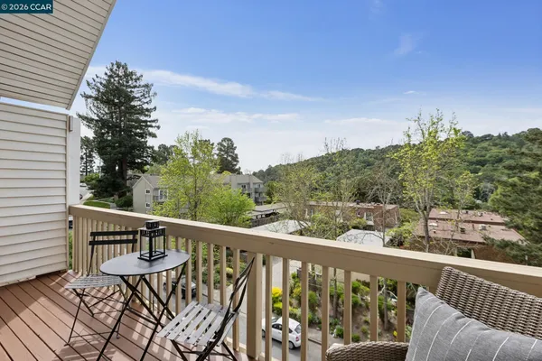 a view of a balcony with wooden fence and floor
