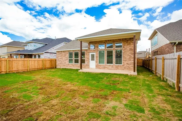 a view of a house with a backyard