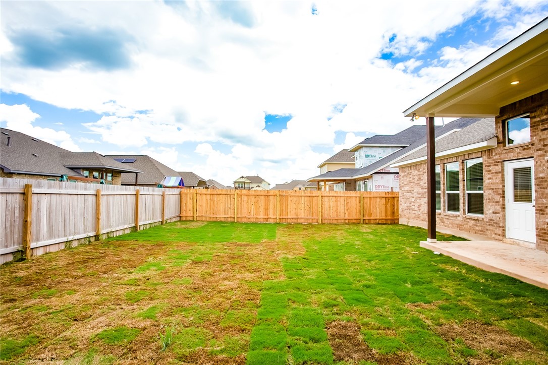 112 Rebel Red Road Liberty Hill, TX 78642 - Photo 28 of 29 a view of a backyard with plants and wooden fence