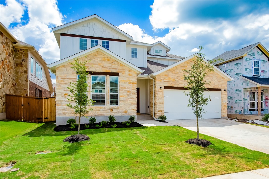 112 Rebel Red Road Liberty Hill, TX 78642 - Photo 3 of 29 a front view of a house with a yard and garage