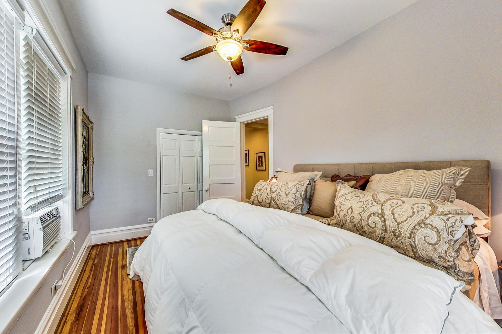 1934 West Grace Street Chicago, IL 60613 - Photo 13 of 34 a bedroom with a large bed and a chandelier
