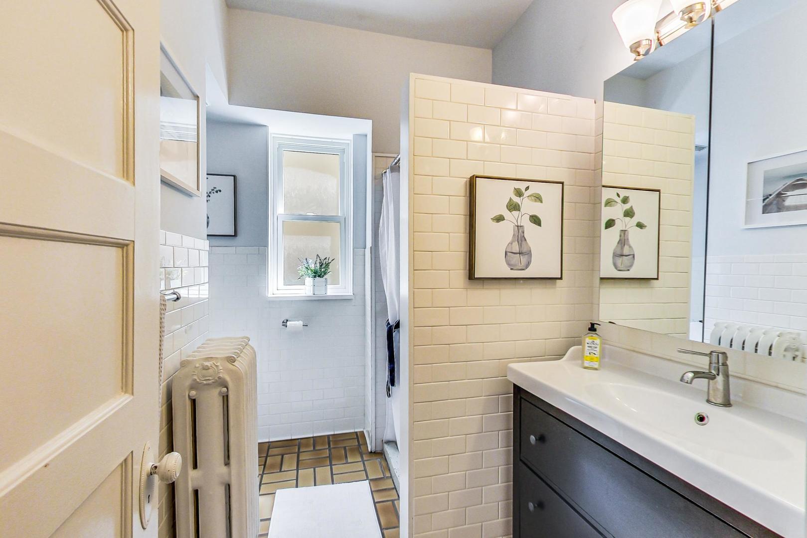 1934 West Grace Street Chicago, IL 60613 - Photo 14 of 34 a bathroom with a sink and mirror