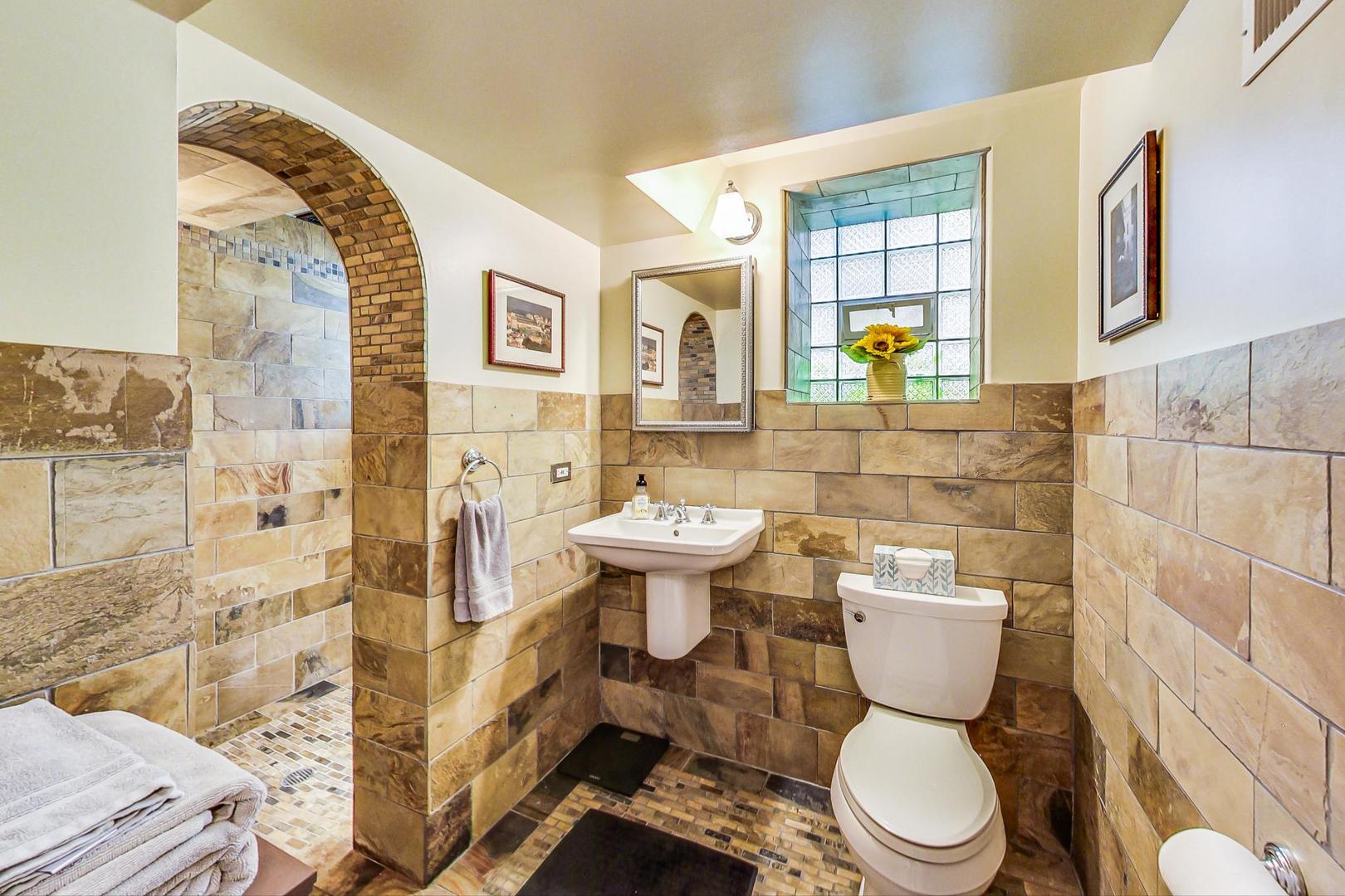 1934 West Grace Street Chicago, IL 60613 - Photo 19 of 34 a bathroom with a toilet sink and mirror