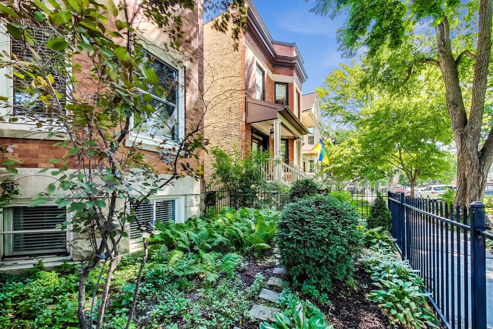 1934 West Grace Street Chicago, IL 60613 - Photo 2 of 34 a view of a house with brick walls plants and large tree