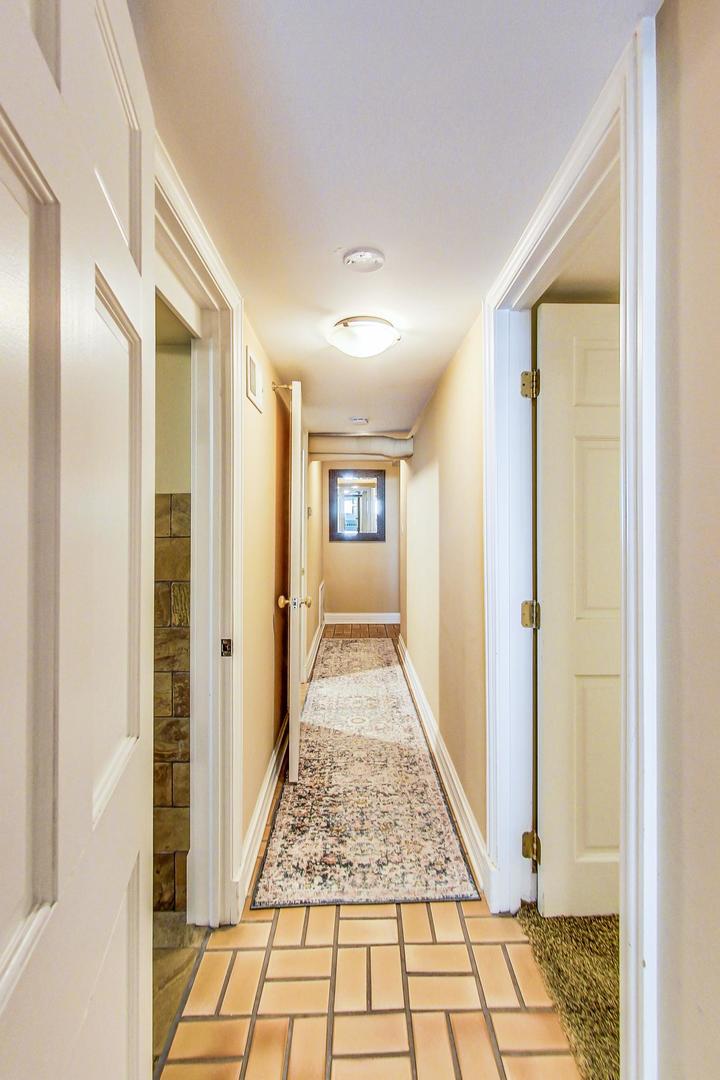 1934 West Grace Street Chicago, IL 60613 - Photo 21 of 34 a view of a hallway view with wooden floor and staircase