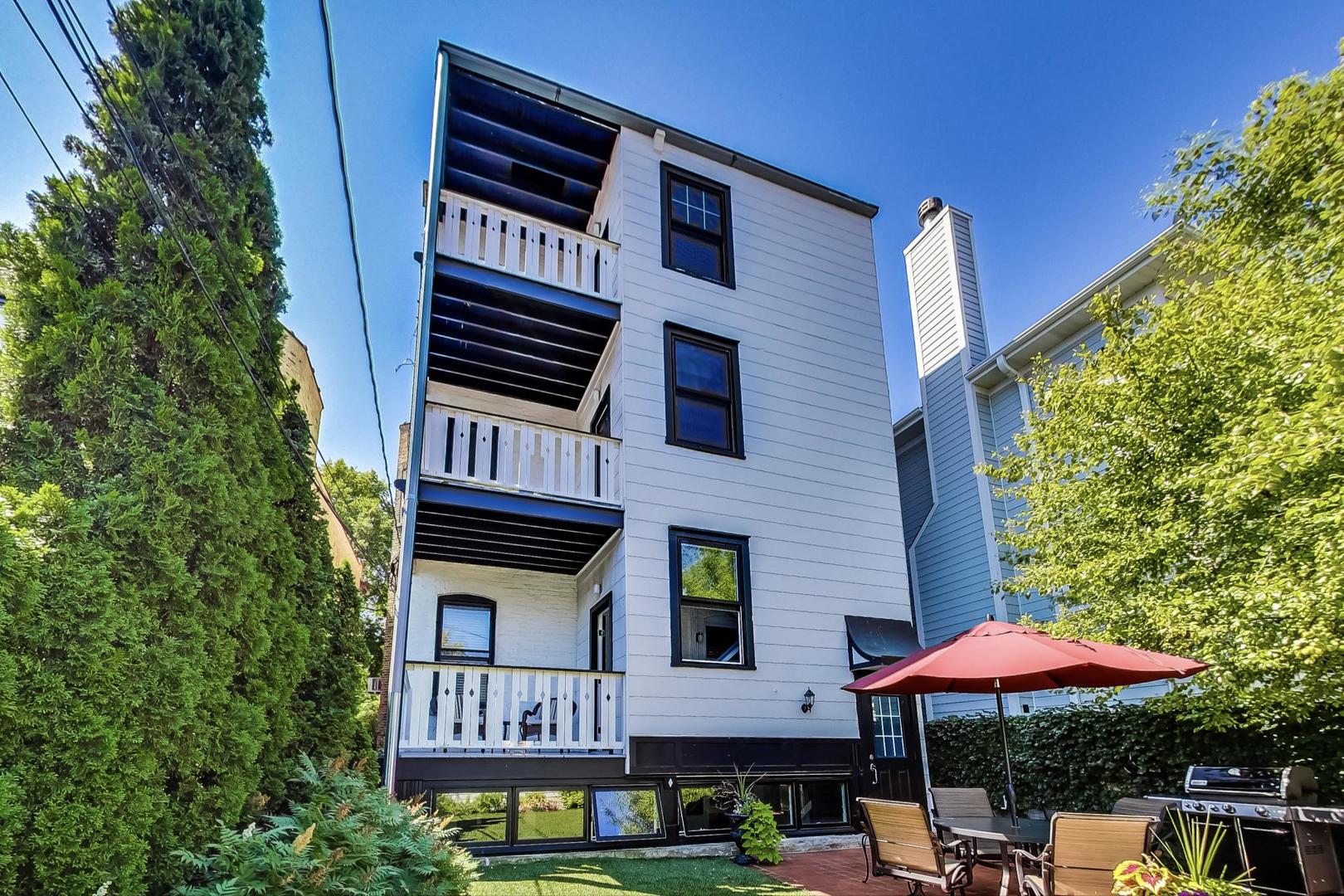1934 West Grace Street Chicago, IL 60613 - Photo 25 of 34 a front view of a building with lots of trees and plants
