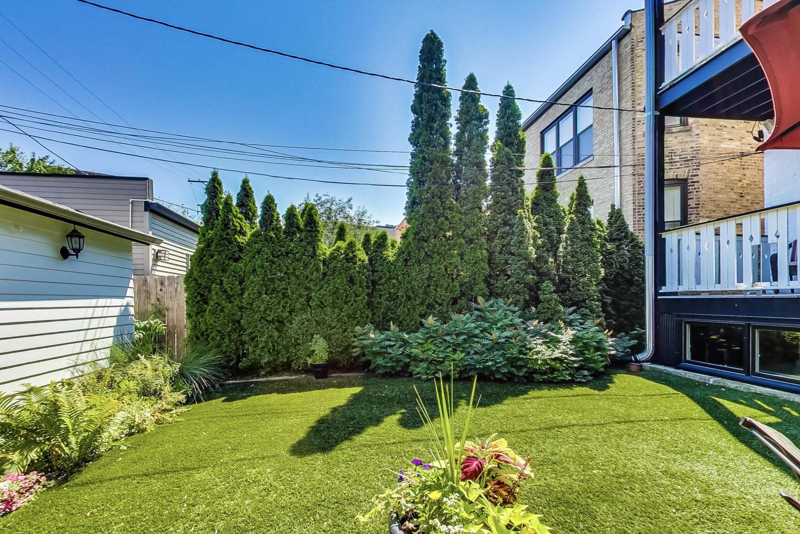 1934 West Grace Street Chicago, IL 60613 - Photo 28 of 34 a view of a house with a yard and potted plants