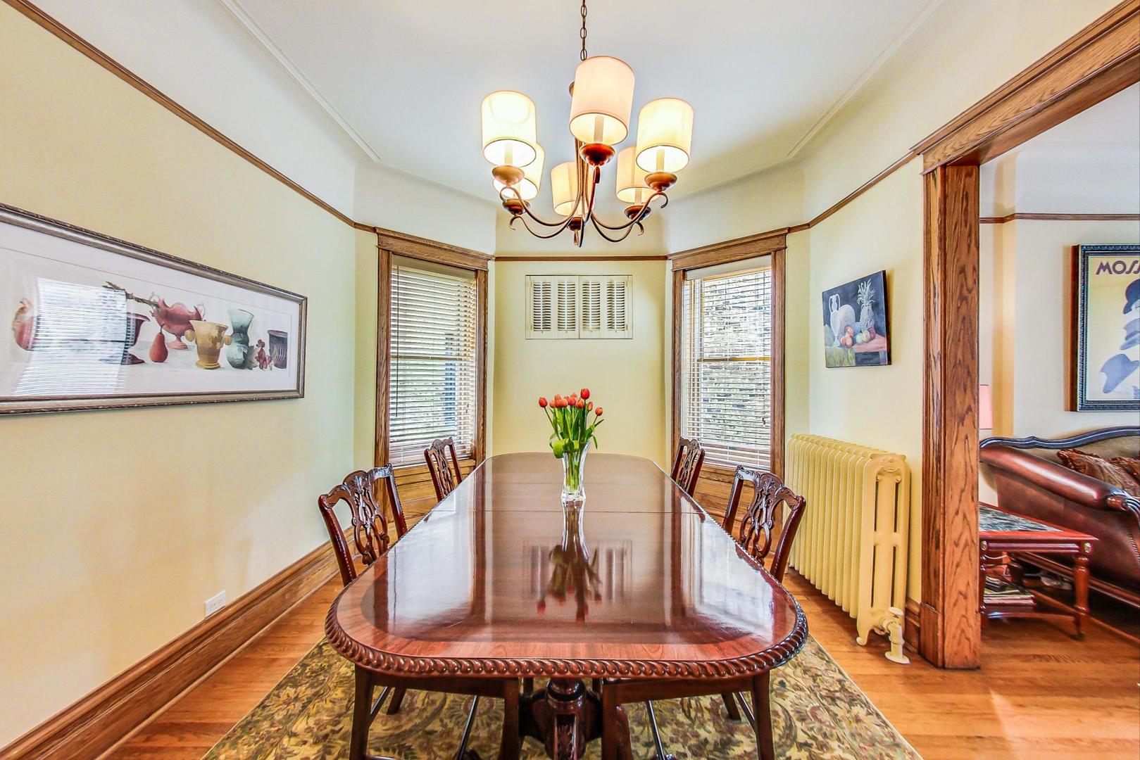 1934 West Grace Street Chicago, IL 60613 - Photo 7 of 34 a view of a dining room with furniture a chandelier and wooden floor