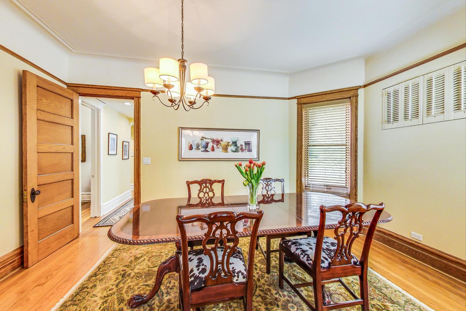 1934 West Grace Street Chicago, IL 60613 - Photo 8 of 34 a view of a dining room with furniture a chandelier and wooden floor