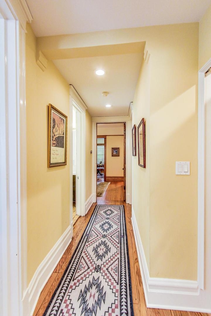 1934 West Grace Street Chicago, IL 60613 - Photo 9 of 34 a hallway with wooden floor and a bookshelf