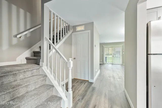 a view of a hallway with wooden floor and entryway