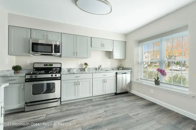 a kitchen with appliances cabinets and a sink