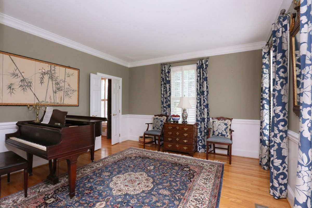 3200 Anderson Drive Raleigh, NC 27609 - Photo 10 of 25 Formal living room features hardwood floors, wainscoting, crown molding and multiple windows with plantation shutters. Formal Living Room