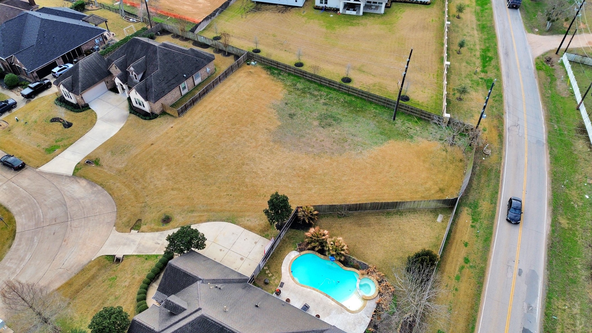 33231 Worthing Lane Fulshear, TX 77441 - Photo 2 of 28 an aerial view of a house with a swimming pool