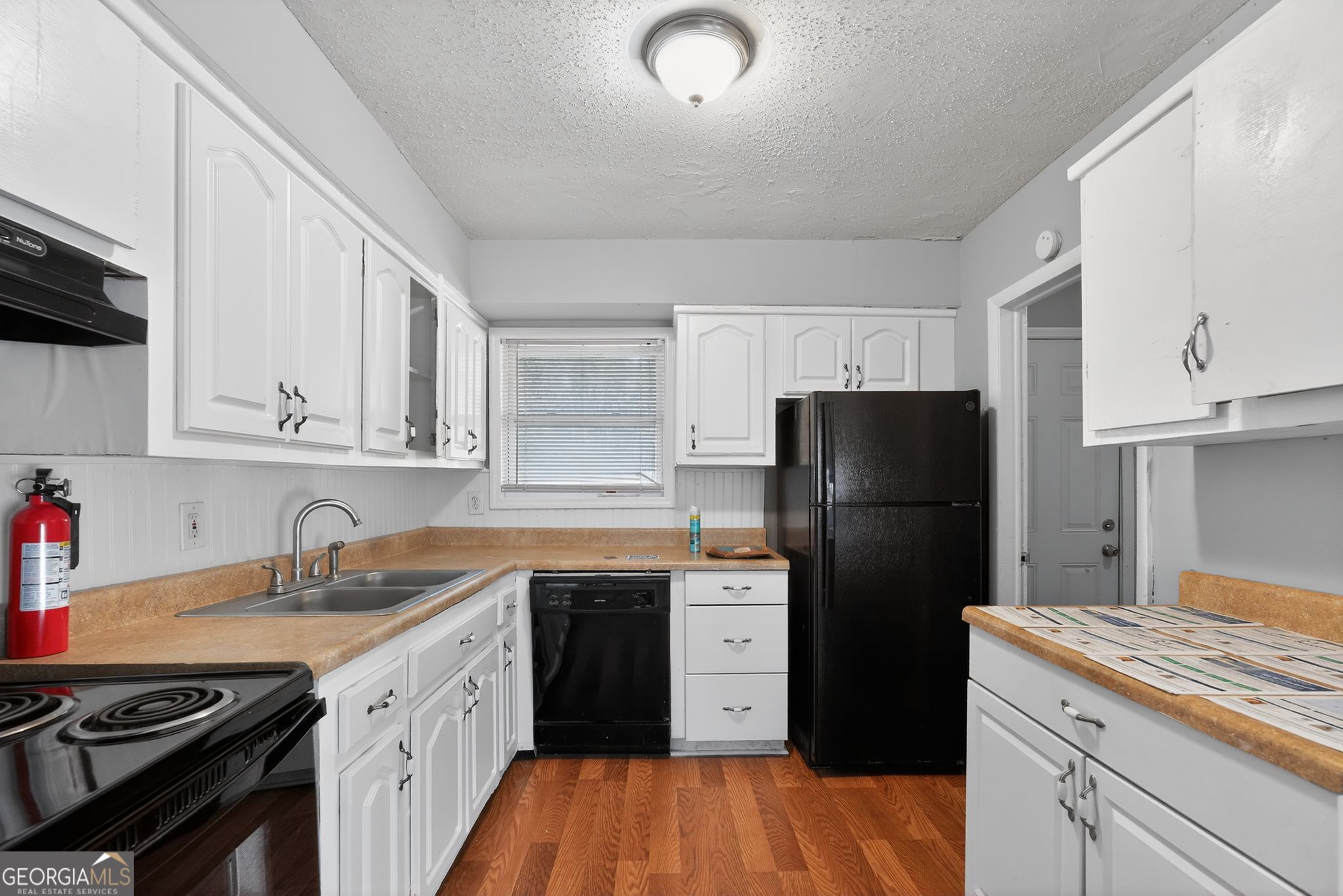 2522 Brentwood Court Decatur, GA 30032 - Photo 11 of 32 a kitchen with a sink a refrigerator and cabinets