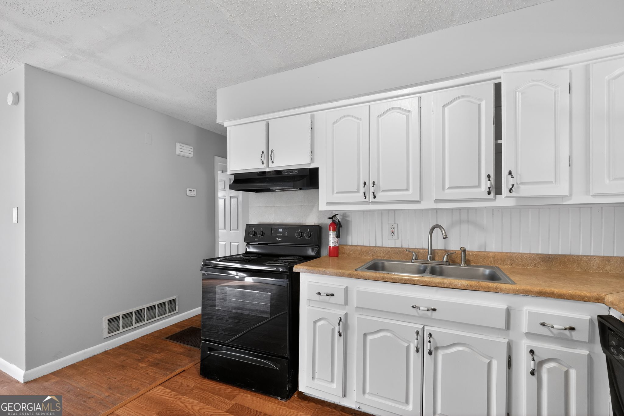 2522 Brentwood Court Decatur, GA 30032 - Photo 12 of 32 a kitchen with white cabinets sink and stainless steel appliances