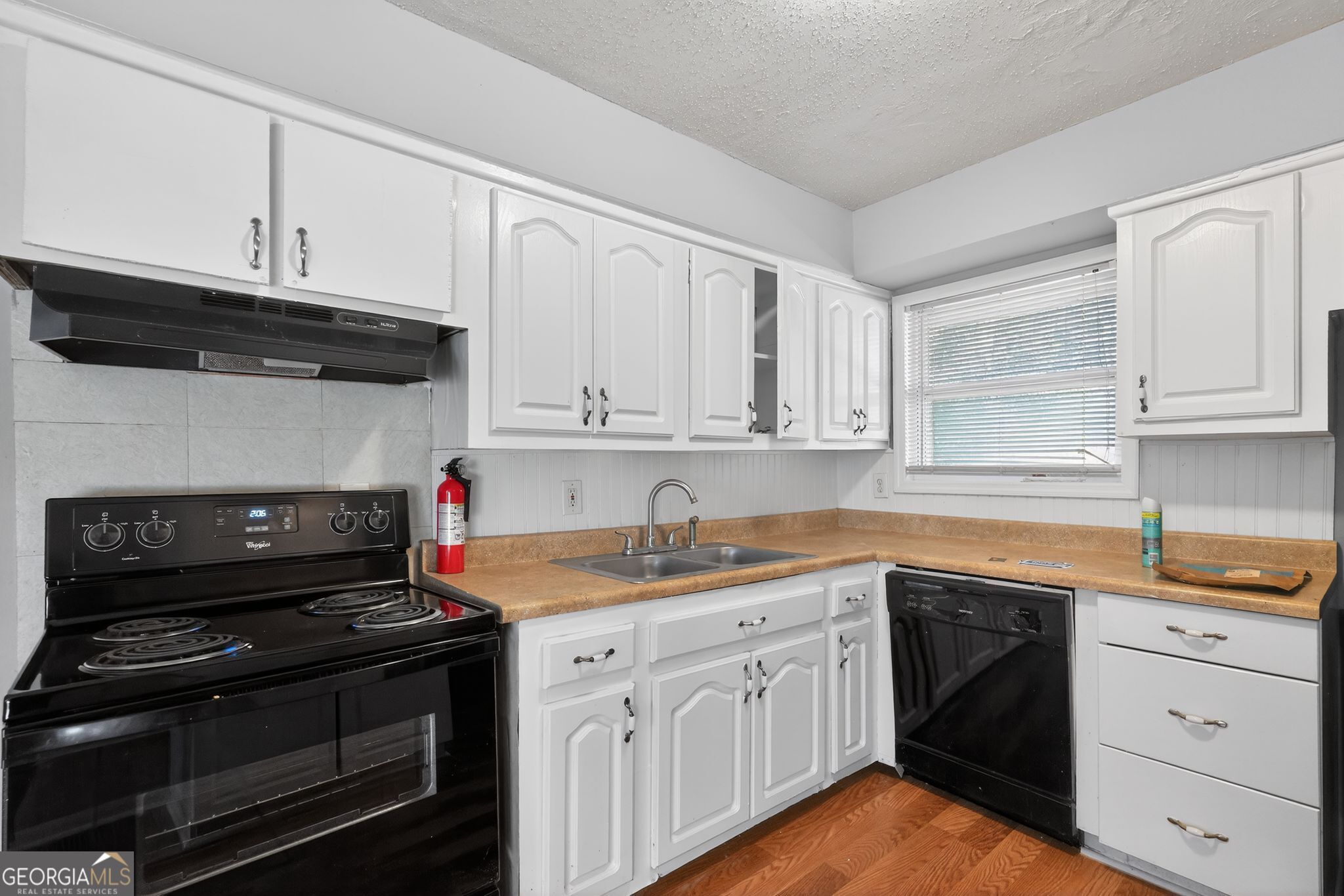 2522 Brentwood Court Decatur, GA 30032 - Photo 13 of 32 a kitchen with white cabinets and appliances