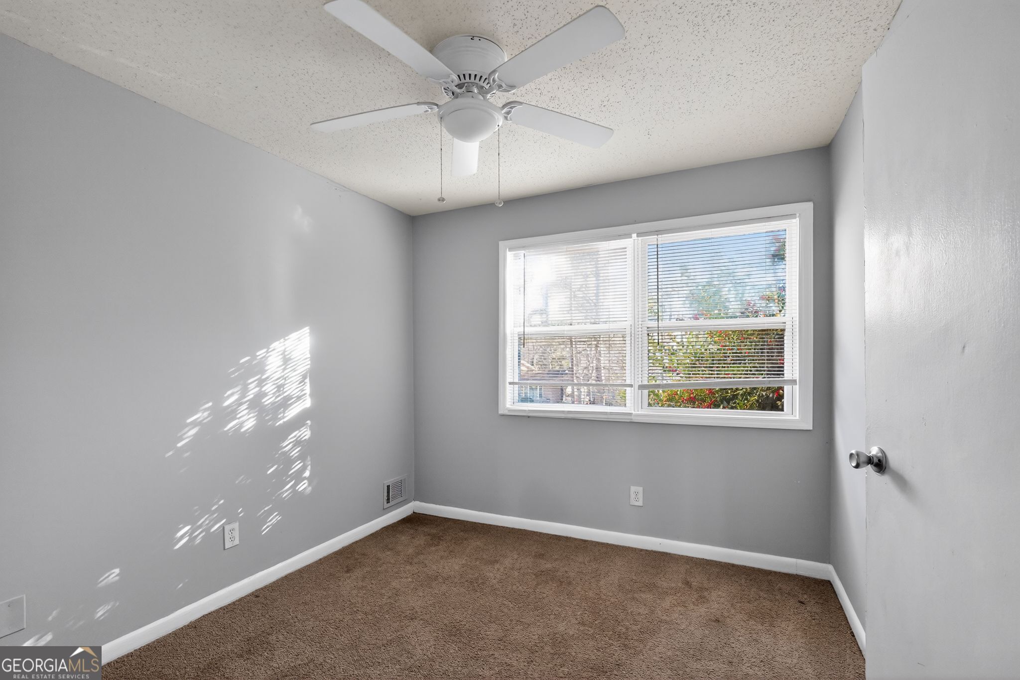 2522 Brentwood Court Decatur, GA 30032 - Photo 20 of 32 en empty room with windows and chandelier fan