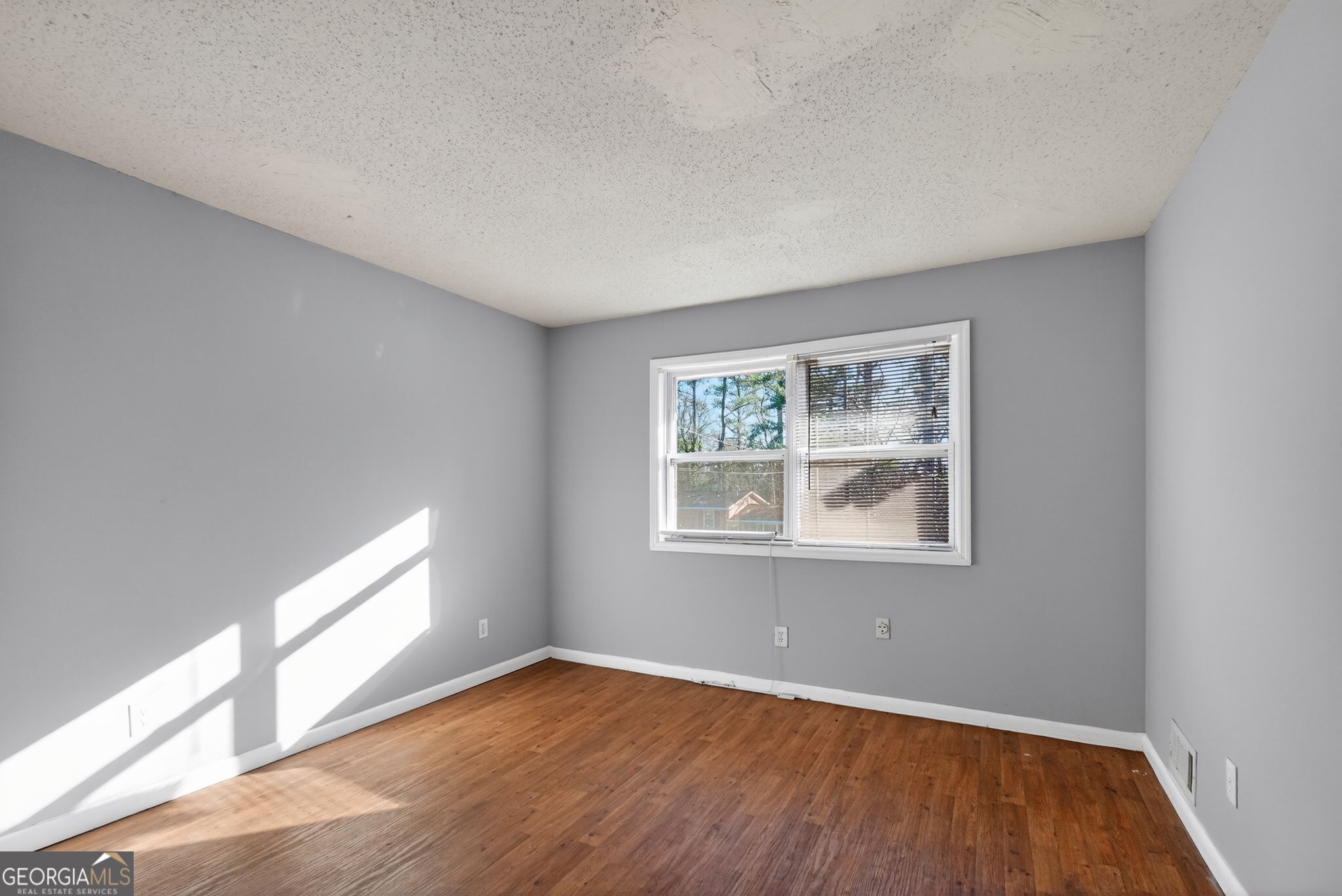 2522 Brentwood Court Decatur, GA 30032 - Photo 8 of 32 a view of an empty room with wooden floor and a window