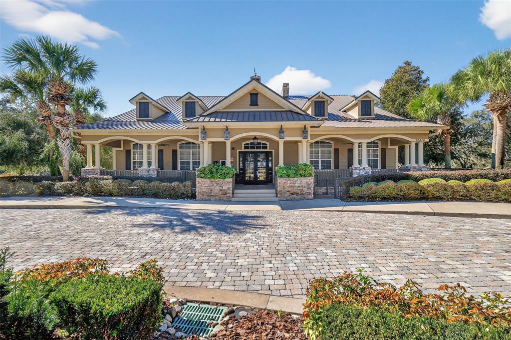 21944 Belgian Court Mount Dora, FL 32757 - Photo 34 of 57 a front view of a house with a yard and potted plants