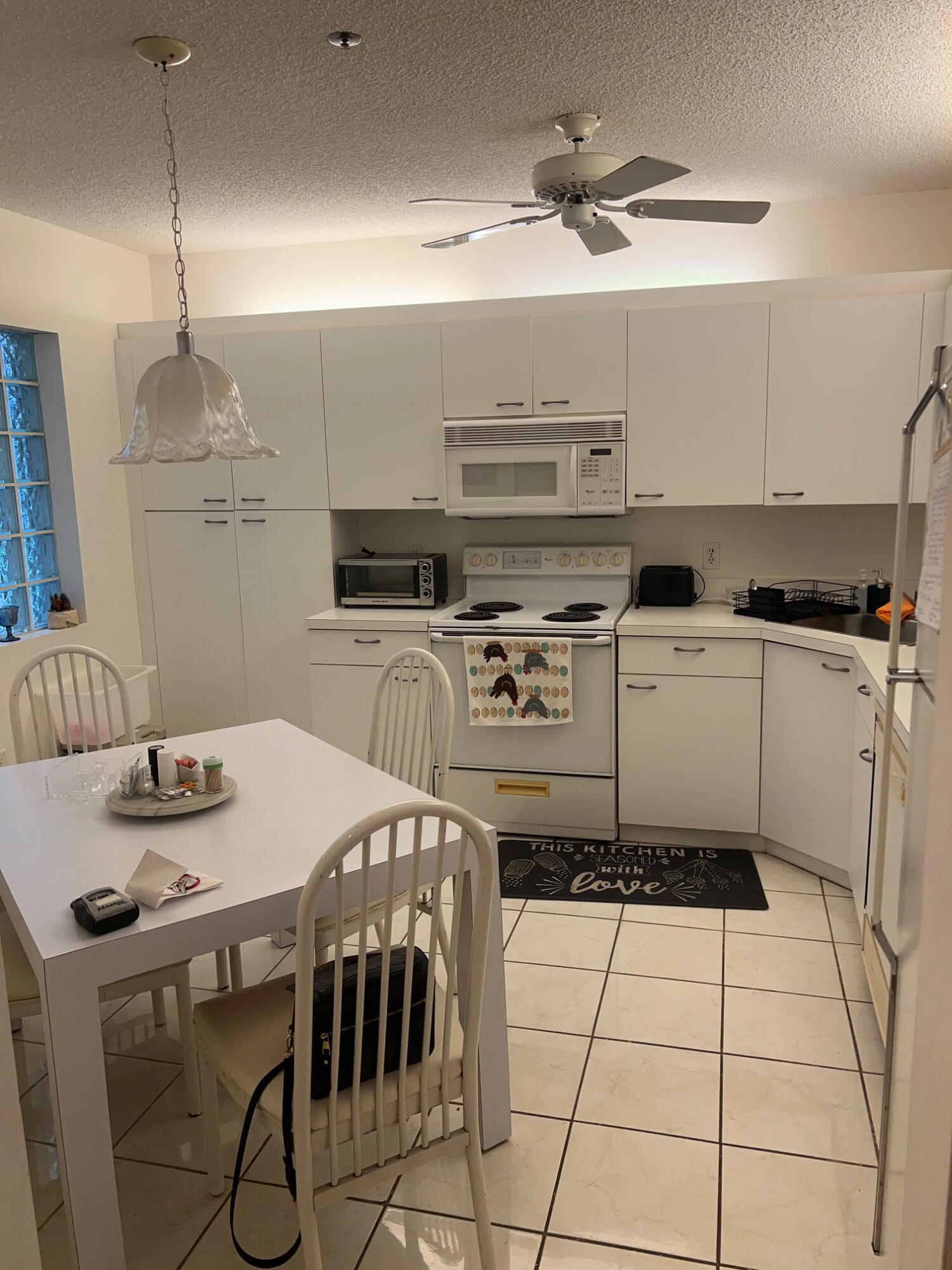 5265 Brisata Circle, Unit E Boynton Beach, FL 33437 - Photo 20 of 30 a kitchen with a stove a sink and a refrigerator