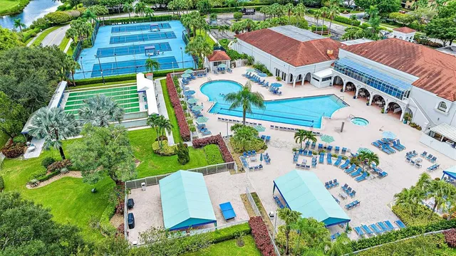 an aerial view of residential houses with outdoor space and parking