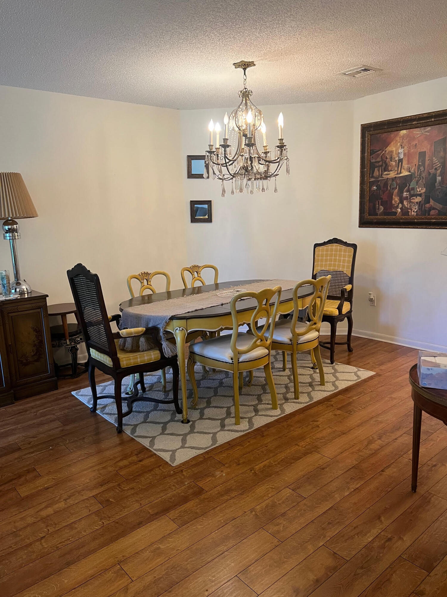5265 Brisata Circle, Unit E Boynton Beach, FL 33437 - Photo 4 of 30 a view of a dining room with furniture a chandelier and wooden floor